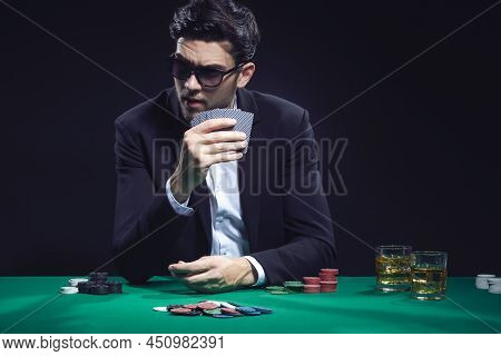 Emotional Handsome Caucasian Brunet Pocker Player At Pocker Table With Chips And Cards While Playing