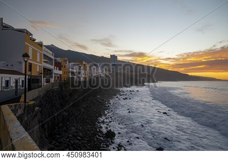 View On Colorful Houses And Black Lava Rocks In Small Village Punta Brava Near Puerto De La Cruz, Te