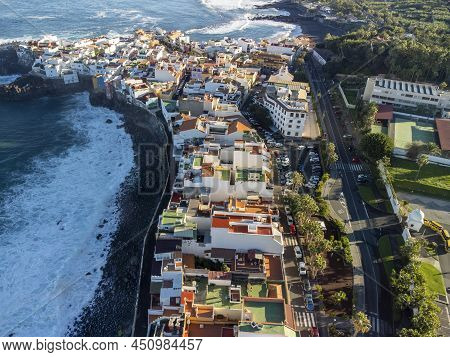 Aerial View On Colorful Houses And Black Lava Rocks In Small Village Punta Brava Near Puerto De La C