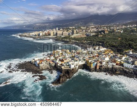 Aerial View On Colorful Houses And Black Lava Rocks In Small Village Punta Brava Near Puerto De La C