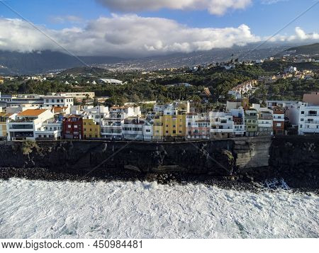 Aerial View On Colorful Houses And Black Lava Rocks In Small Village Punta Brava Near Puerto De La C