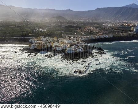 Aerial View On Colorful Houses , Top Of Mount Teide And Black Lava Rocks In Small Village Punta Brav