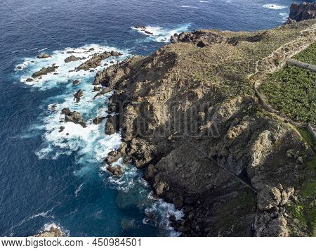 Aerial View On Charco Del Viento Natural Pool In Black Lava Rocks And Banana Tree Plantation On Tene
