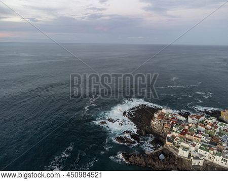 Aerial View On Colorful Houses And Black Lava Rocks In Small Village Punta Brava Near Puerto De La C