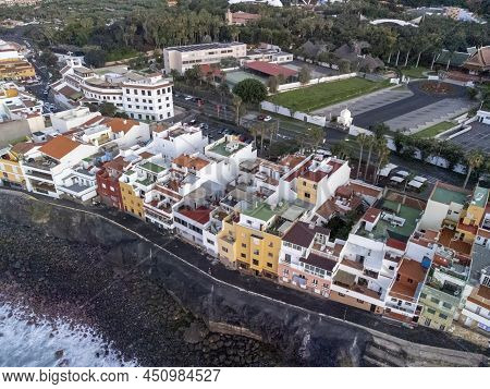 Aerial View On Colorful Houses And Black Lava Rocks In Small Village Punta Brava Near Puerto De La C