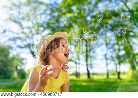 A Child Eats Ice Cream In The Summer When It\'s Hot Outside. Ice Cream In A Waffle Cone. A Happy And