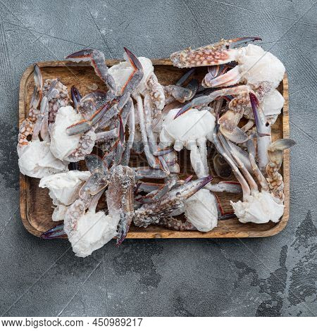 Frozen Raw Blue Swimming Crab Claws Set, On Wooden Tray, On Gray Background