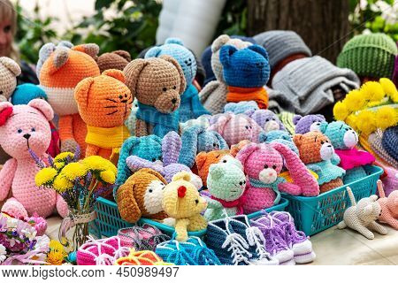 Cute Soft Handmade Colorful Knitted Toys For Children In Blue Plastic Baskets Put Up For Sale Agains