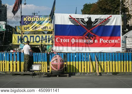 Kyiv, Ukraine - August 5, 2014: Man Standing Near A Euromaidan Barricade With A Banner Saying Stop F