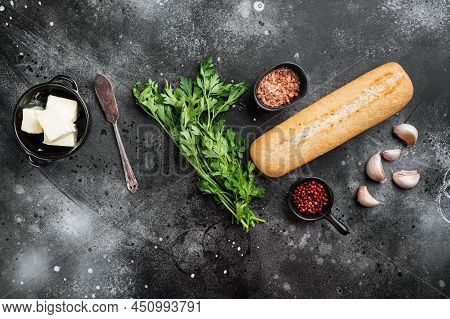 Ingredients For Garlic And Gerbs Bread Baguette Set, On Black Dark Stone Table Background, Top View 