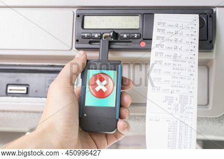 Driver Holding A Digital Tachograph Reader With Big Red Cross Mark On The Screen. Tachograph Downloa