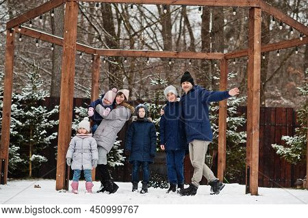 Big Young Family With Four Kids In Winter Day.