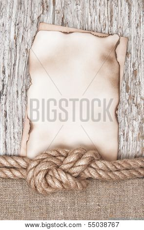 Aged Paper With Ship Rope On The Old Wood