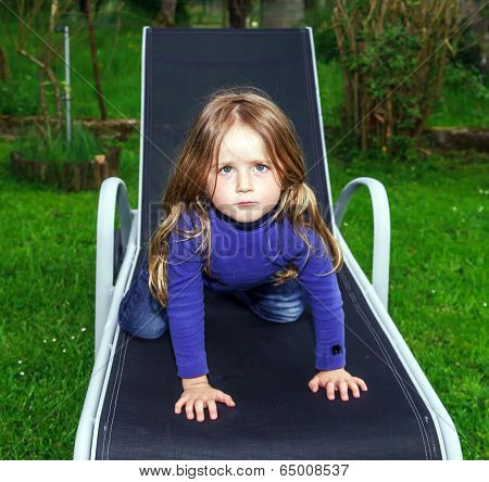 Cute Little Girl On Sling Chair