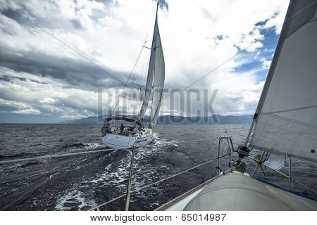 AEGEAN SEA, GREECE - MAY 5, 2014: Unidentified sailboats participate in sailing regatta 