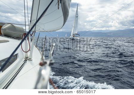 AEGEAN SEA, GREECE - MAY 5, 2014: Unidentified sailboats participate in sailing regatta 