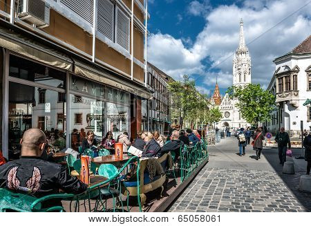 Tourists Sitting In A Sidewalk Cafe Near Matthias Church
