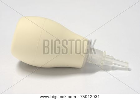 Baby nasal aspirator on white table