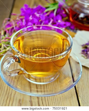 Tea from fireweed in glass cup on board