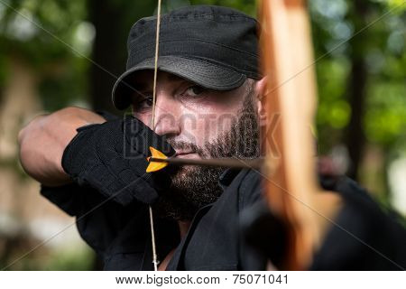 Man With A Bow And Arrows In Woods