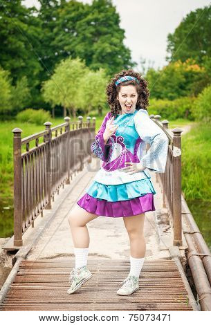 Young Beautiful Girl In Irish Dance Dress And Wig Having Fun