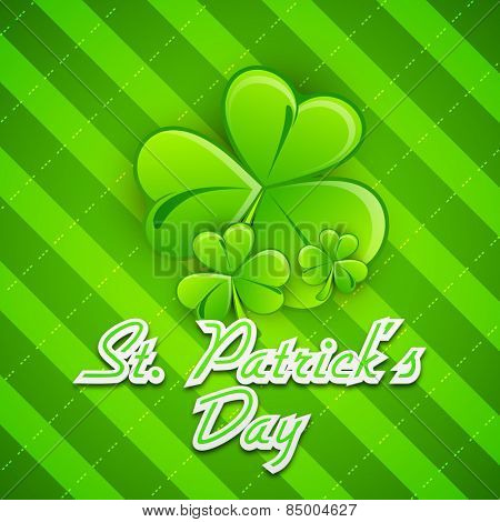 Happy St. Patrick's Day celebration greeting card design with glossy Irish lucky shamrock leaves on green background.