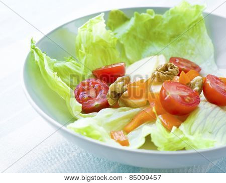 Healthy mixed green salad with nuts.
