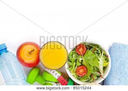 Dumbells, tape measure, healthy food and towels. Fitness and health. Isolated on white background