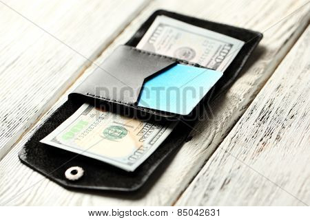 Hand made leather man wallet with money on white wooden background