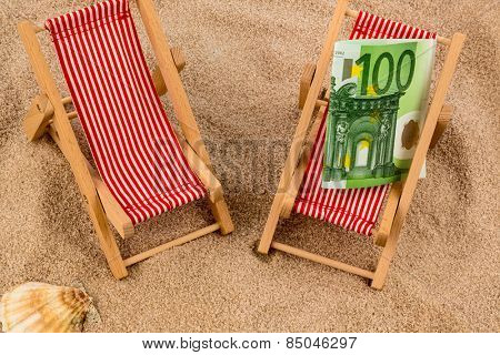 beach chair with euro currency on the sandy beach. symbolic photo for cost of travel, vacation, holidays