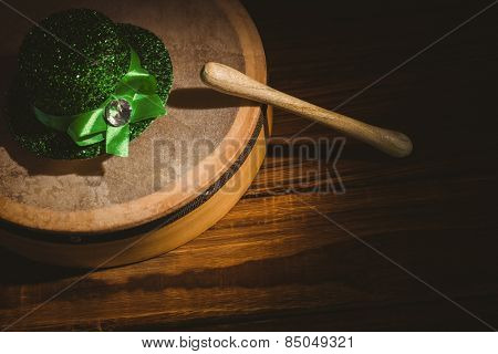 Traditional Irish bodhran and stick on wooden table