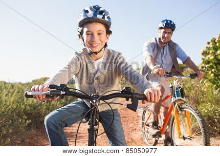 Father and son on a bike ride on a sunny day