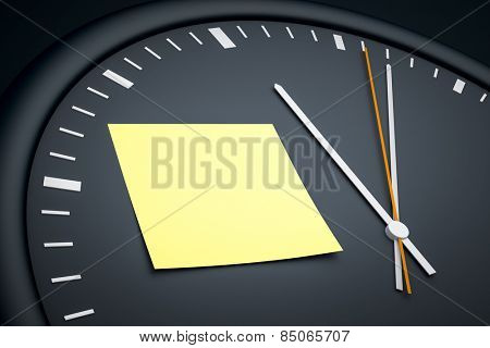 An image of a dark clock with a sticky note