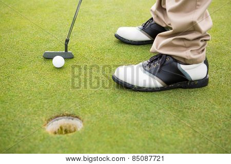 Golfer about to tee off on a sunny day at the golf course