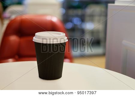 Paper Cup Of Hot Coffee With Red Chair Background