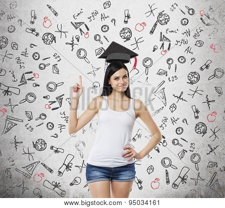 Brunette Lady Is Presents A Necessity Of Higher Education. Graduation Hat Above Her Head. Educationa