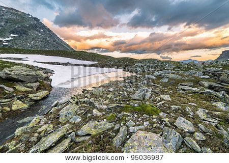 High Altitude Alpine Lake And Cloudscape At Sunset