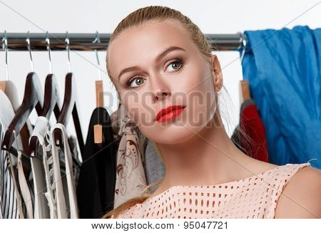 Beautiful Blonde Woman Suffering Near Wardrobe Rack
