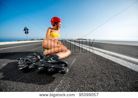 Woman in swimsuit with rollers on the highway