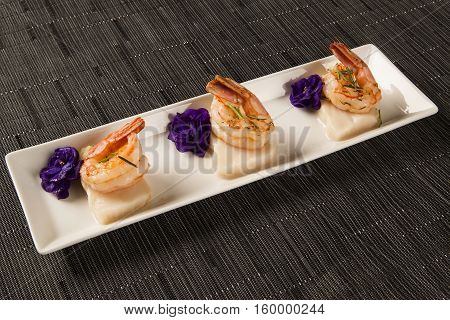Grilled Shrimp With Raw Nail Fish On White Plate At Table