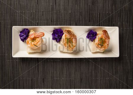 Grilled Shrimp With Raw Nail Fish On White Plate At Table