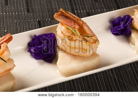 Grilled Shrimp With Raw Nail Fish On White Plate At Table