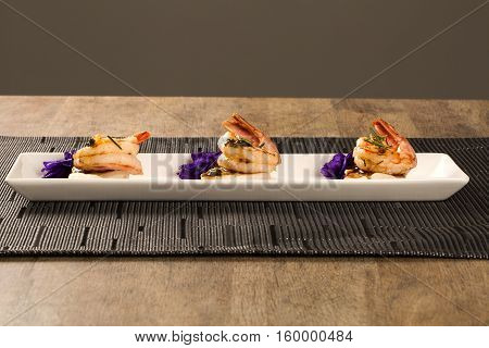 Grilled Shrimp With Raw Nail Fish On White Plate At Table