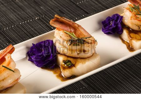 Grilled Shrimp With Raw Nail Fish On White Plate At Table