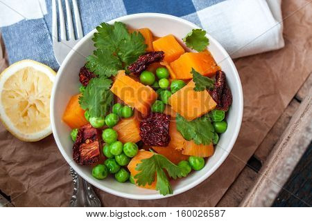 Vegan garnish. Boiled sweet potatoes with green peas cilantro and linseed oil. Perfect for the detox diet or just a healthy meal. Love for a healthy raw food concept.