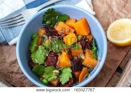 Vegan garnish. Boiled sweet potatoes with green peas cilantro and linseed oil. Perfect for the detox diet or just a healthy meal. Love for a healthy raw food concept.