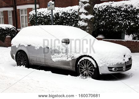 London, UK, December, 19 2010: A heavy snow fall covering a car in a Kilburn street bringing transport to a standstill