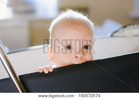 small child slobbering black carriage in the apartment