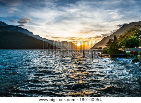 Storm and wind on the lake of Swiss Alps. Splash of waves in the setting sun. High Dynamic Range Image.
