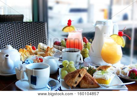 Afternoon tea with pastries, tea and juices